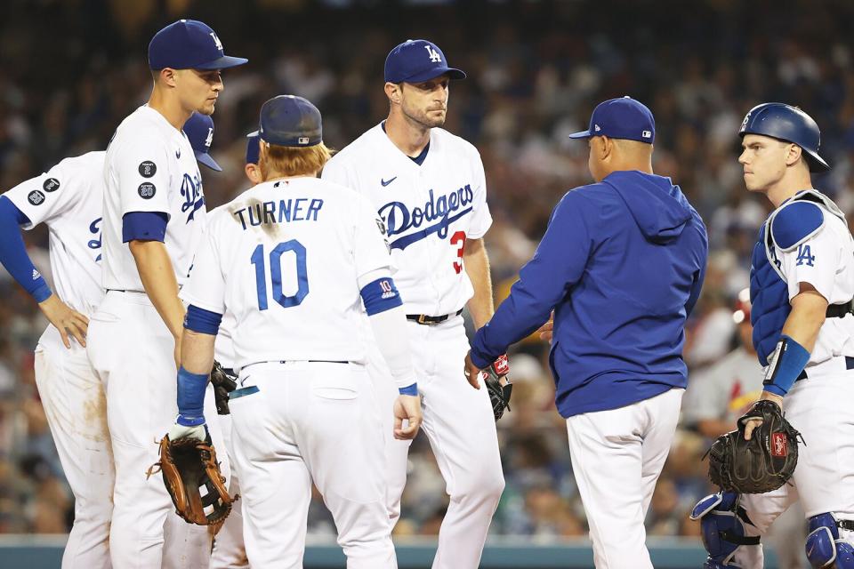 Manager Dave Roberts #30 pulls Max Scherzer #31 of the Los Angeles Dodgers from the game in the fifth inning against the St. Louis Cardinals during the National League Wild Card Game at Dodger Stadium on October 06, 2021 in Los Angeles, California.