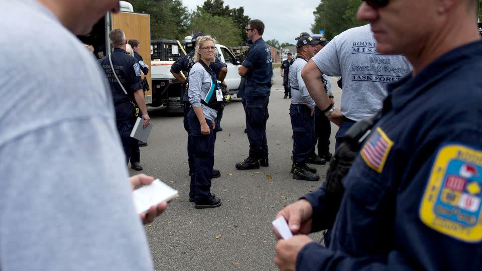 Members of Missouri Search and Rescue, part of FEMA, unload their gear at a staging area as Hurricane Florence starts to make landfall in Lealand, North Carolina, on September 13, 2018. - Andrew Caballero-Reynoolds/AFP/Getty Images