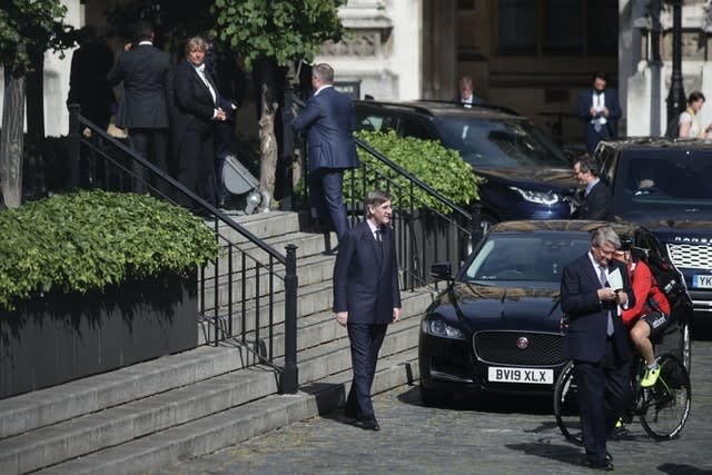 Members of Parliament, including Leader of the House of Commons Jacob Rees-Mogg, queue outside the House of Commons (Aaron Chown/PA)