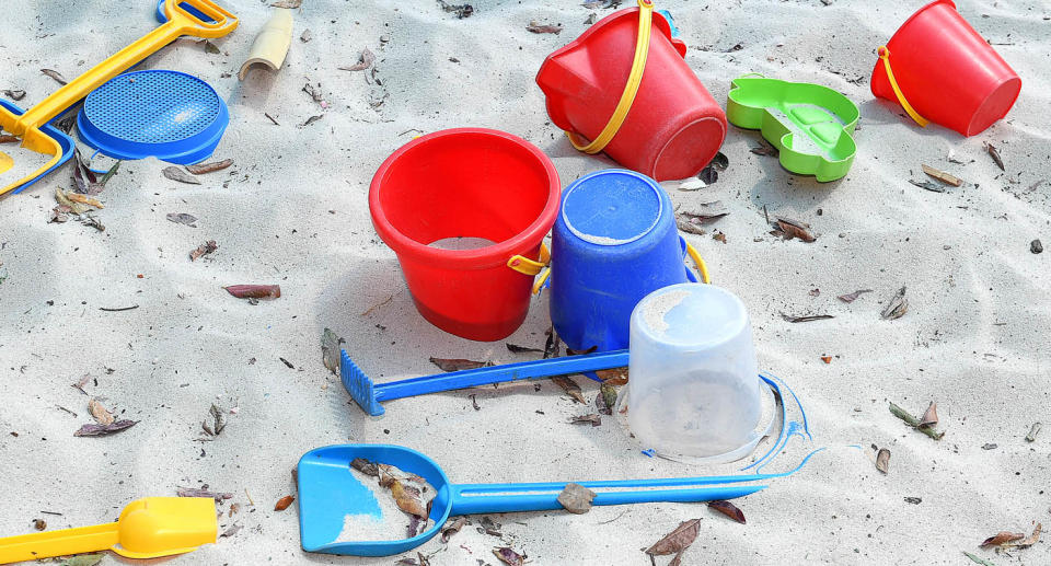 File photo of plastic buckets and shovels in a sandpit. Source: AAP