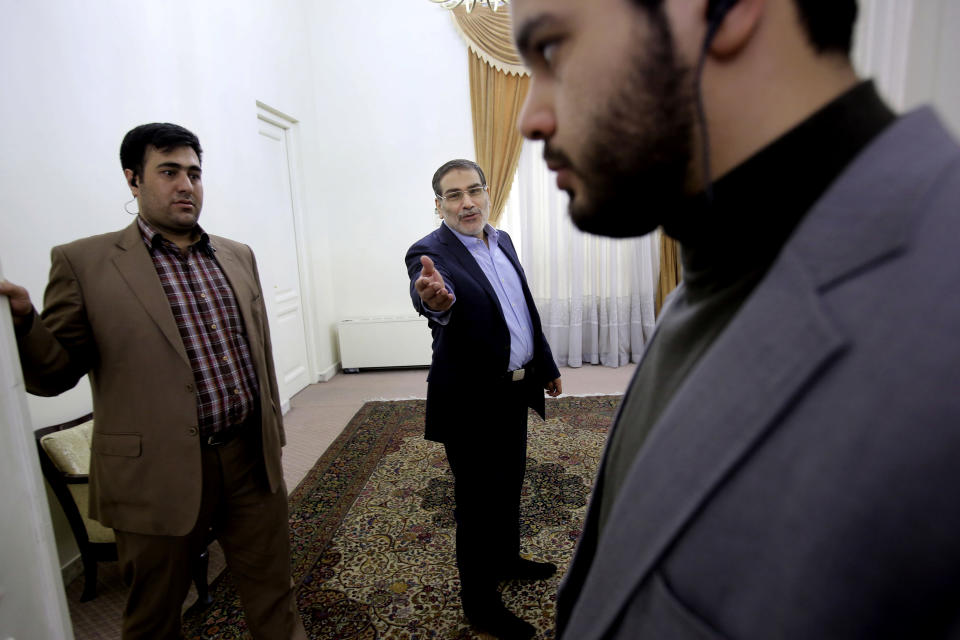 Secretary of Iran's Supreme National Security Council, Ali Shamkhani, center, advises security to allow photojournalists take photographs after meeting with former United Nations Secretary-General Kofi Annan and Mexico's former President Ernesto Zedillo in Tehran, Iran, Tuesday, Jan. 28, 2014. (AP Photo/Vahid Salemi)