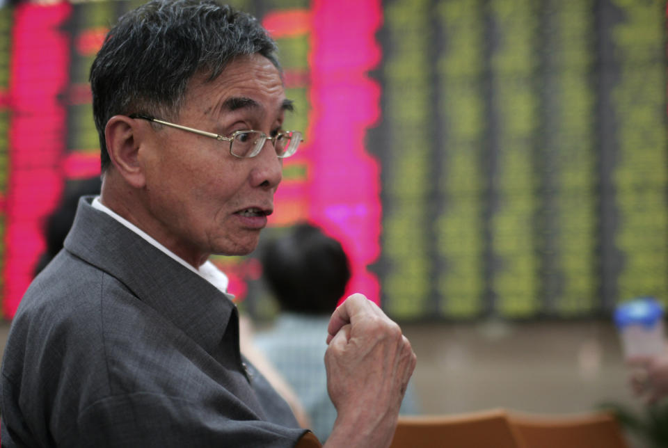 An investor gestures as he looks at the stock price monitor at a private securities company Tuesday May 15, 2012 in Shanghai, China. Asian stock markets were mostly lower Tuesday, rattled by a political impasse in Greece that could lead the debt-stricken country to a destabilizing exit from the euro currency union. (AP Photo)