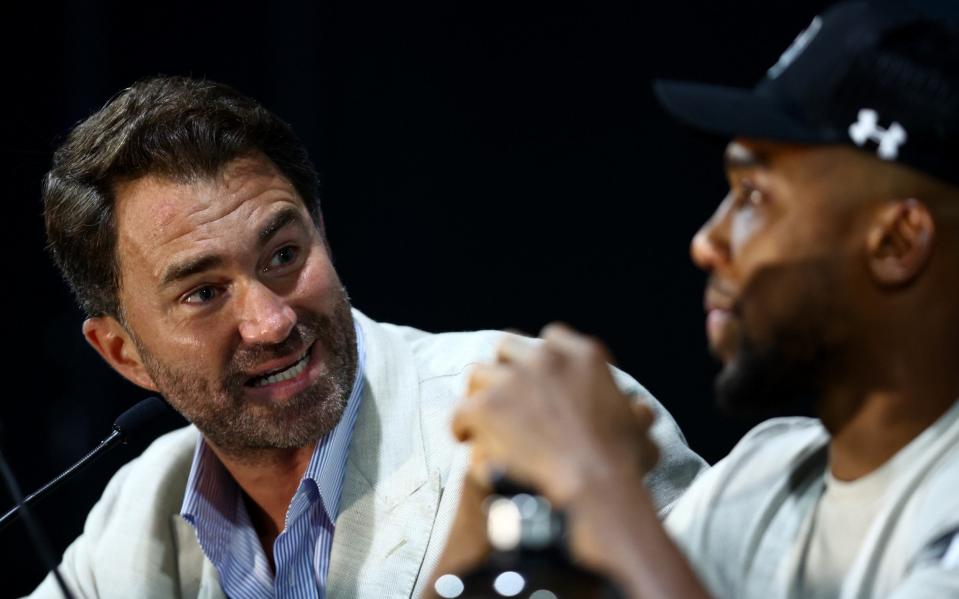 Eddie Hearn speaks with Anthony Joshua - GETTY IMAGES