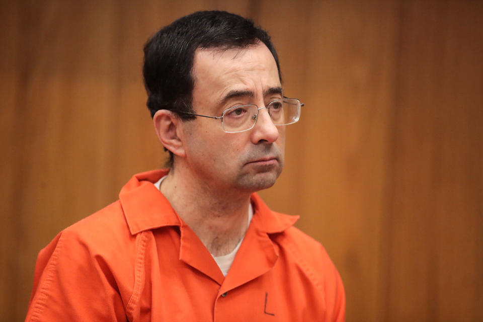 Larry Nassar stands as he is sentenced by Judge Janice Cunningham for three counts of criminal sexual assault in Eaton County Circuit Court on Feb. 5, 2018, in Charlotte, Mich. (Scott Olson / Getty Images file)