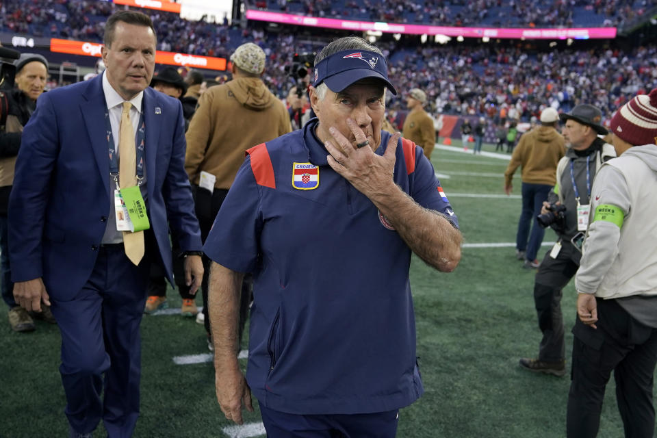 New England Patriots head coach Bill Belichick, center, steps off the field following the team's loss to the Washington Commanders in an NFL football game, Sunday, Nov. 5, 2023, in Foxborough, Mass. (AP Photo/Charles Krupa)
