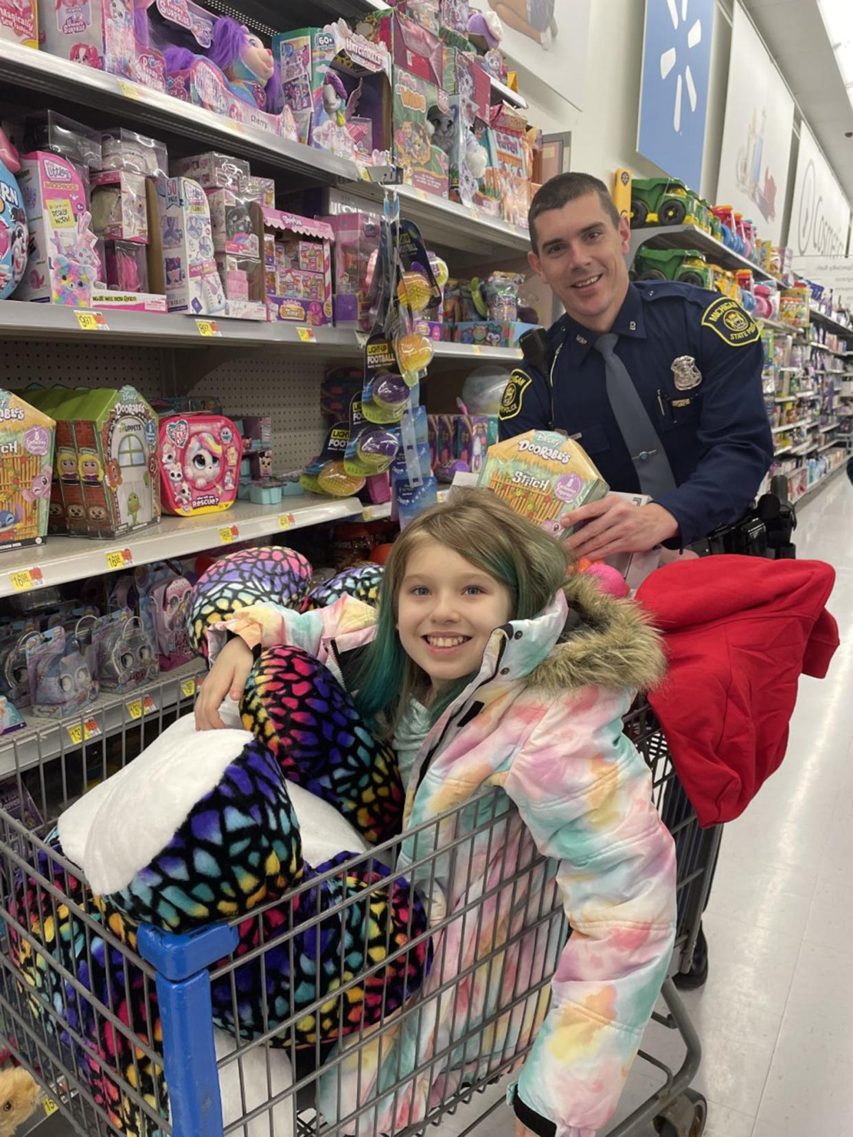 Nine-year-old Summer Lahaie shops with Michigan State Police troopers on Wednesday, Nov. 30 at the Walmart in Cheboygan.