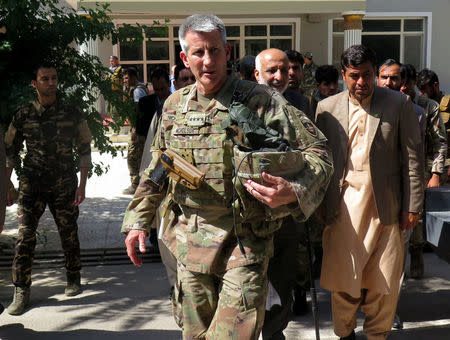 U.S. Army General John Nicholson, commander of Resolute Support forces and U.S. forces in Afghanistan, walks with Afghan officials during an official visit in Farah province, Afghanistan May 19, 2018. REUTERS/James Mackenzie