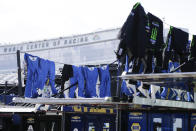 Crew members' fire suits dry out in the garage area before the restart of the NASCAR Daytona 500 auto race at Daytona International Speedway, Monday, Feb. 17, 2020, in Daytona Beach, Fla. Sunday's race was postponed because of rain. (AP Photo/Terry Renna)