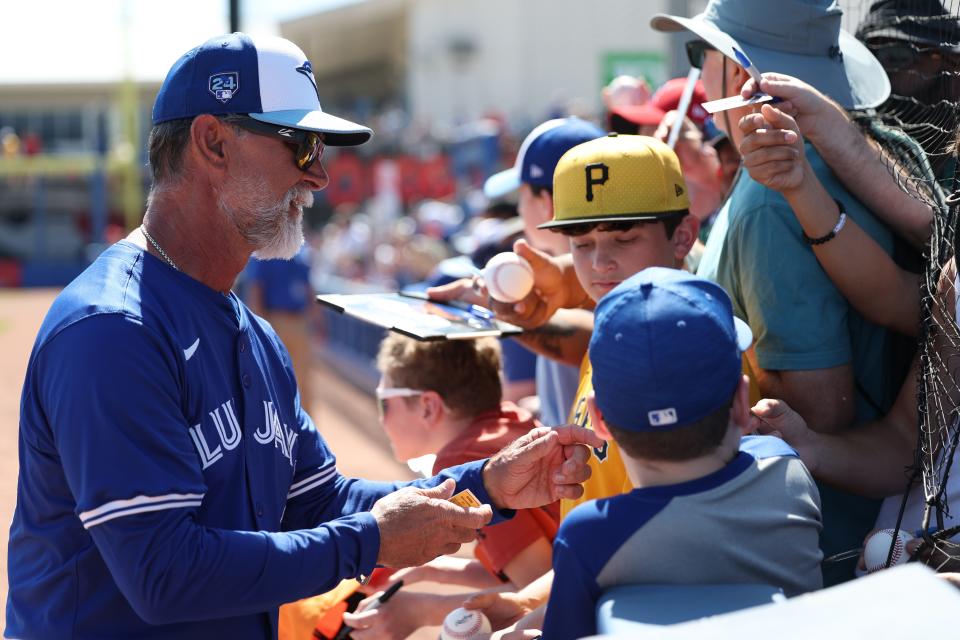 Feb 26, 2024; Dunedin, Florida, USA; Toronto Blue Jays bench coach Don Mattingly (23) signs autographs before a game against the Pittsburgh Pirates at TD Ballpark. Mandatory Credit: Nathan Ray Seebeck-USA TODAY Sports