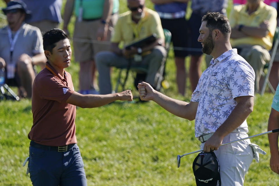 Collin Morikawa fist bumps Jon Rahm following the second round of the Memorial golf tournament, Saturday, June 5, 2021, in Dublin, Ohio. (AP Photo/Darron Cummings)