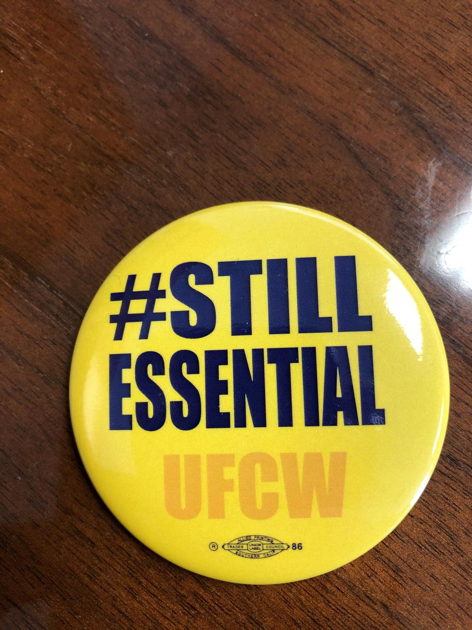 A UFCW union button worn by Kroger workers in campaign during the COVID-19 pandemic.