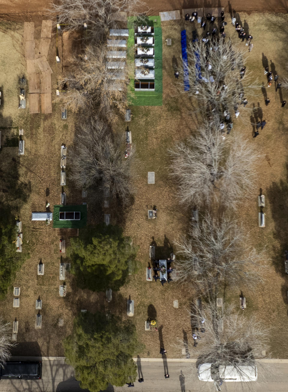 In this image taken with a drone, pallbearers carry a casket during the graveside service for the Earl and Haight families at the cemetery Friday, Jan. 13, 2023, in La Verkin, Utah. Tausha Haight, her mother, Gail Earl, and her five children were shot and killed by her husband Jan. 4. (Rick Egan/The Salt Lake Tribune via AP)