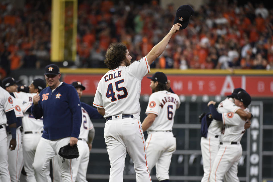 Houston Astros starting pitcher Gerrit Cole (45) celebrates with teammates after their win over the Tampa Bay Rays in Game 5 of a baseball American League Division Series in Houston, Thursday, Oct. 10, 2019. (AP Photo/Eric Christian Smith)