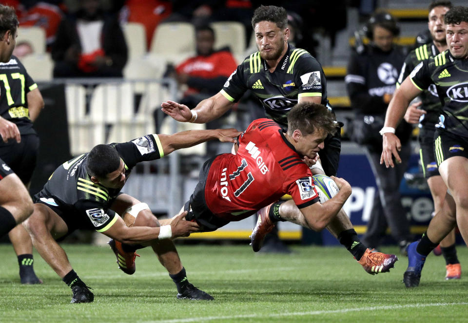 Crusaders George Bridge os airborne as he scores a try during the Super Rugby game between the Crusaders and Hurricanes in Christchurch, New Zealand, Saturday, Feb. 23, 2019. (AP Photo/Mark Baker)