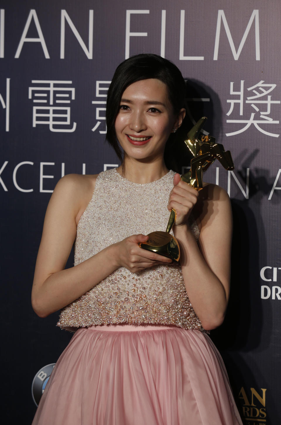 Chinese actress Jiang Shu Ying celebrates after winning the Best Newcomer for her movie "So Young" of the Asian Film Awards in Macau Thursday, March 27, 2014. (AP Photo/Kin Cheung)