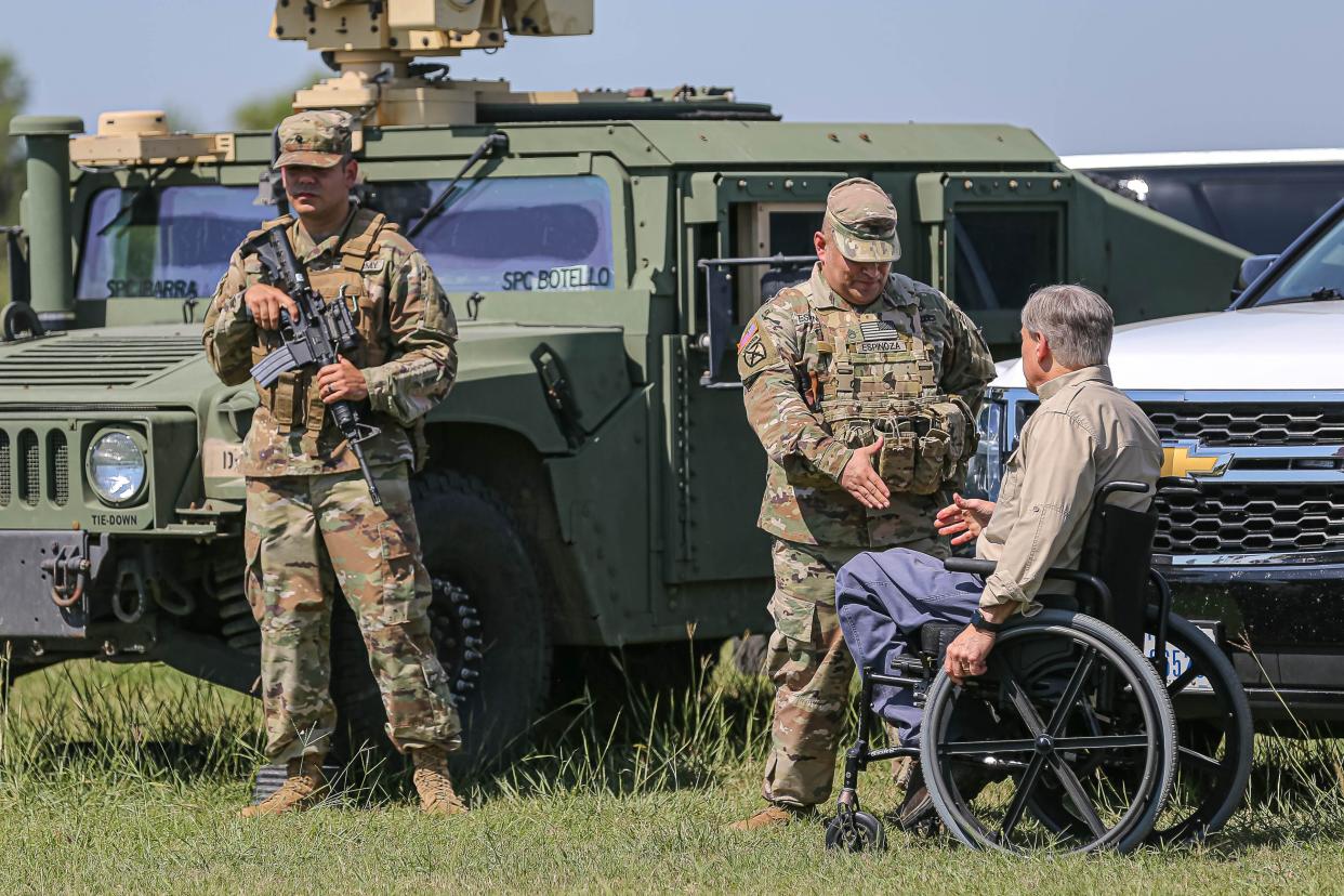 Gov. Greg Abbott greets a Texas National Guard member before a press conference on the southern border in Mission, on Oct. 6, 2021.