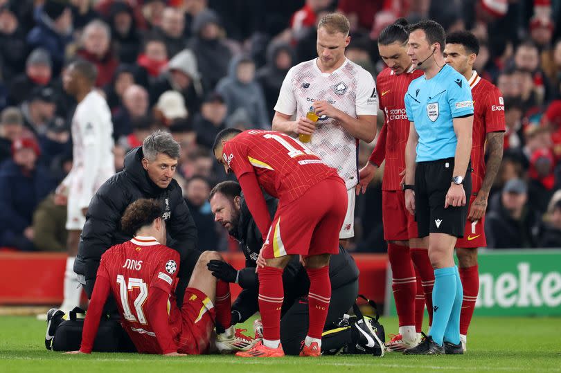 Curtis Jones receives medical treatment during Liverpool's Champions League game against Lille.