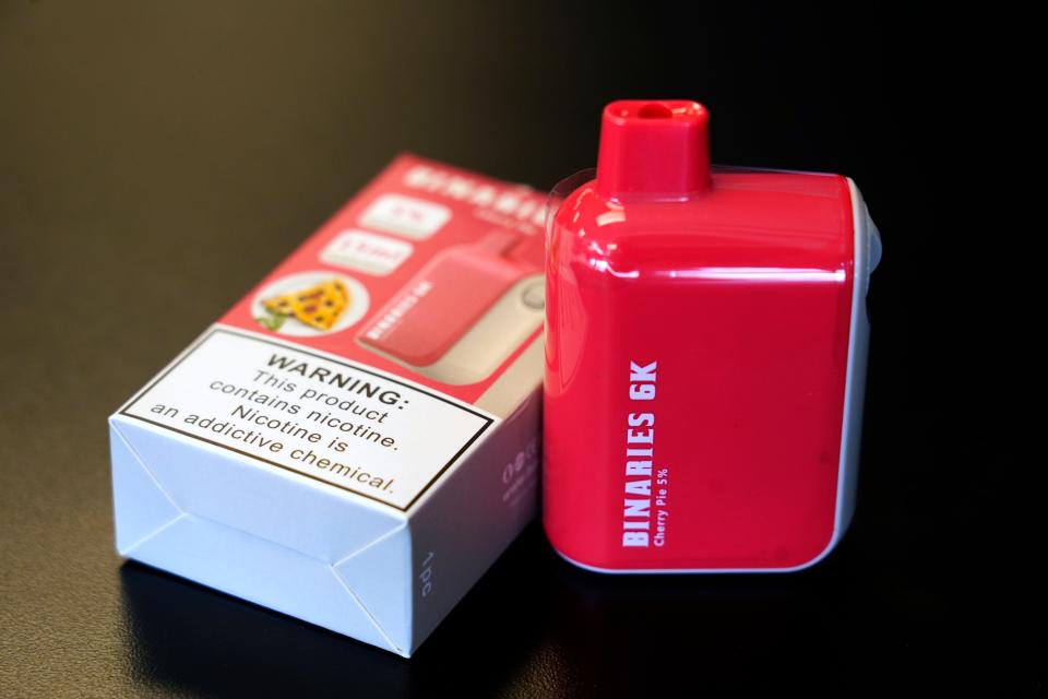 A cherry flavor Binaries 6K disposable is sold to adult customers, 21 and older, at Cincy Vapors in Fairfield. The device comes in a variety of flavors and has 6,000 puffs. According to owner, Jeff Kathman, these contain three to five times the amount of nicotine as a traditional cigarette.