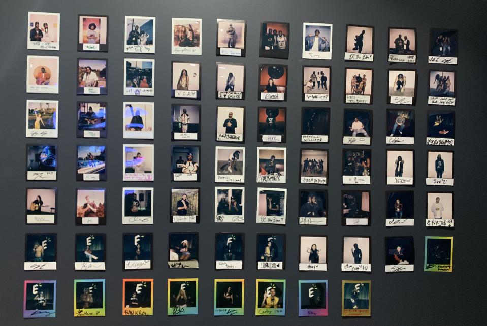 Wall at Encore Studios displaying signed polaroids of artists who visited and or performed while the app was in Beta mode. - Credit: DeMicia Inman/VIBE