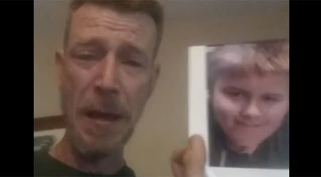 Mr Fitzpatrick held up a picture of his son during the video on Facebook. Source: Facebook