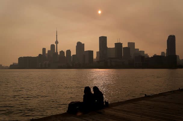 PHOTO: People watch the sunset as the smoke from wildfires is visible in Toronto on June 28, 2023. (Chris Young/AP)