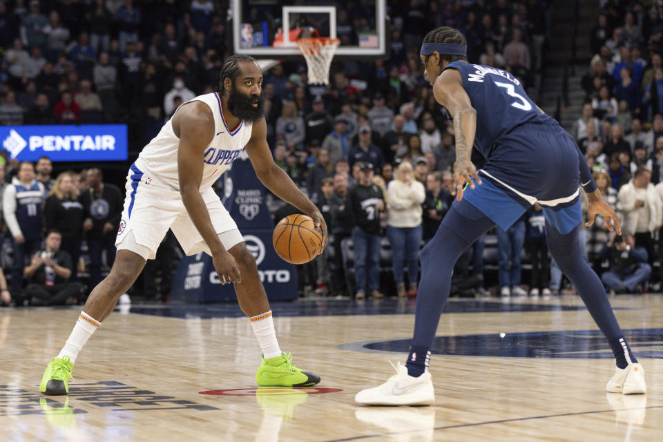 Los Angeles Clippers guard James Harden dribbles while Minnesota Timberwolves forward Jaden McDaniels (3) defends during the first half of an NBA basketball gam,e Sunday, Jan. 14, 2024, in Minneapolis, Minn. (AP Photo/Bailey Hillesheim)