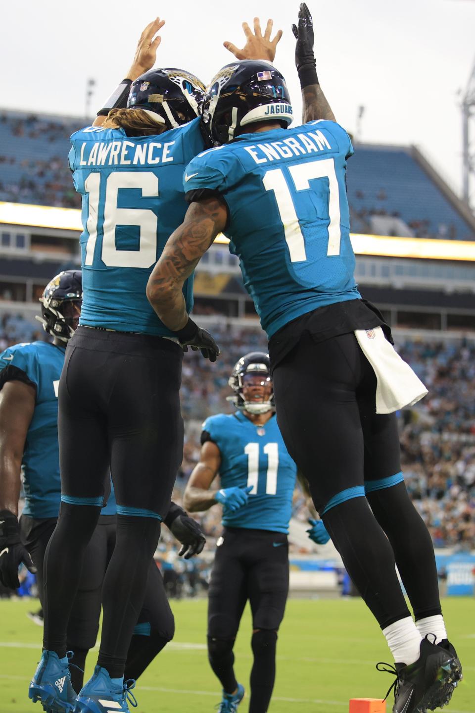 Jacksonville Jaguars quarterback Trevor Lawrence (16) celebrates his touchdown pass to Jacksonville Jaguars tight end Evan Engram (17) during the second quarter of a preseason NFL game against the Cleveland Browns on Friday, Aug. 12, 2022 at TIAA Bank Field in Jacksonville. [Corey Perrine/Florida Times-Union]