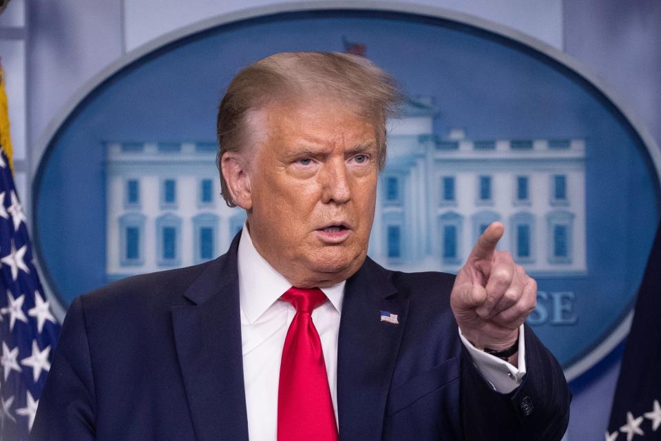 FILE - President Donald Trump points to a question as he speaks during a briefing with reporters in the James Brady Press Briefing Room of the White House.  TikTok and its U.S. employees are planning to take the Trump administration to court over a sweeping order that could ban the popular video app, according to a lawyer preparing one of the lawsuits.