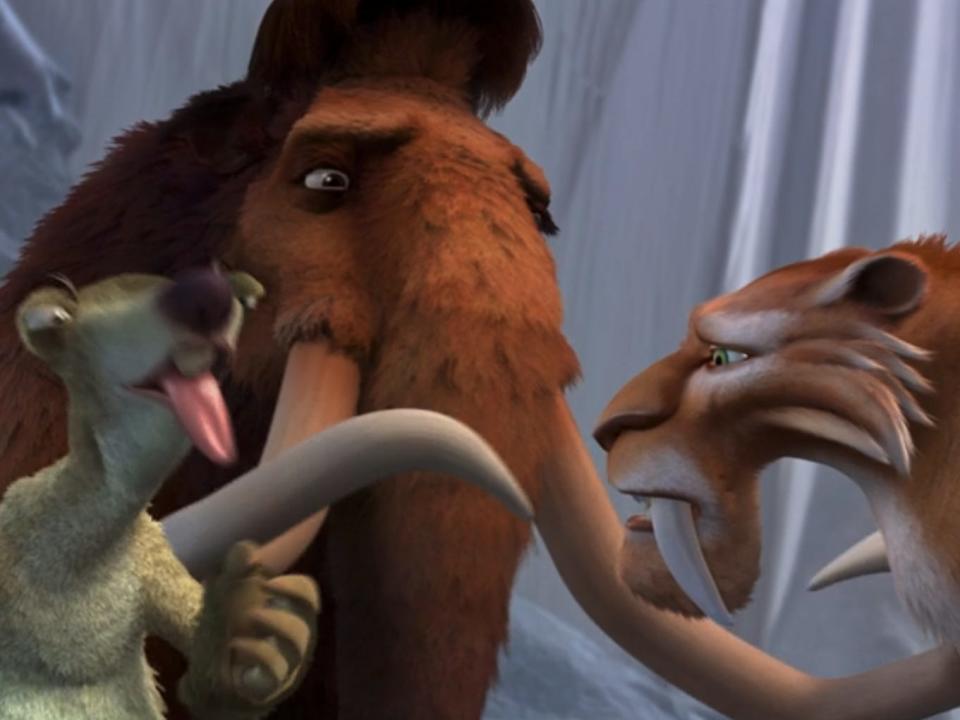 an animated sloth, woolly mammoth, and saber toothed tiger, in Ice Age. the sloth is sticking its tongue out as if it's tasted something bad, while the mammoth and the tiger look at each other with concerned expressions.