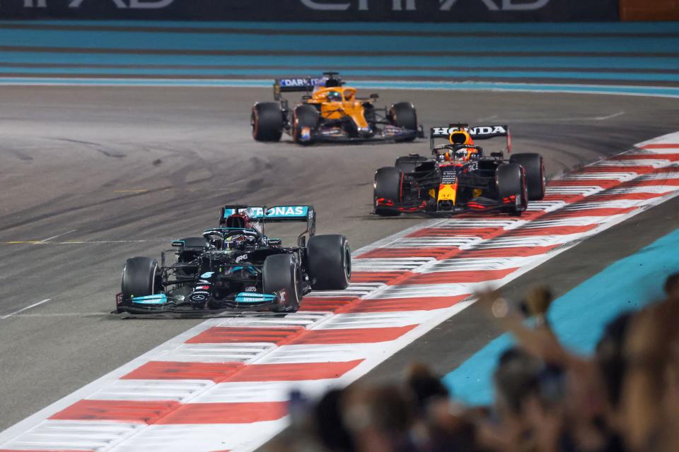 Mercedes' British driver Lewis Hamilton 2021 (Front) is followed by Red Bull's Dutch driver Max Verstappen at the Yas Marina Circuit during the Abu Dhabi Formula 1 Grand Prix on December 12, 2021. - Max Verstappen became the first Dutchman ever to win the Formula One world championship title when he won a dramatic season-ending Abu Dhabi Grand Prix. (Photo by Giuseppe CACACE / AFP) (Photo by GIUSEPPE CACACE/AFP via Getty Images)