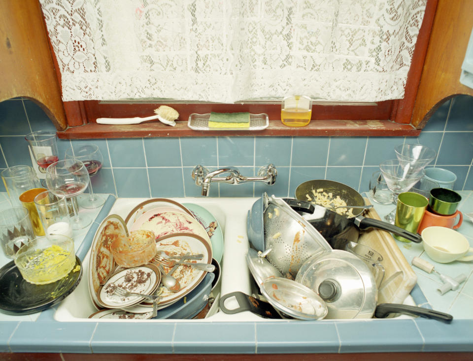 Kitchen sink filled with dirty dishes and utensils