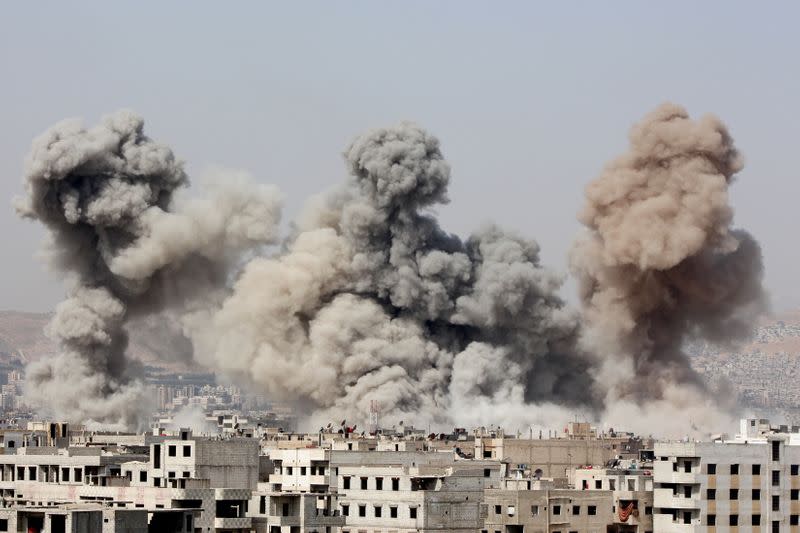 FILE PHOTO: Smoke rises after what activists said were air strikes by forces loyal to Syria's President Bashar al-Assad in Arbeen, in the eastern Damascus suburb of Ghouta