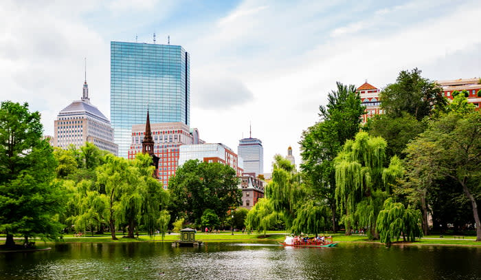 Boston skyline is shown, with a park in the foreground.