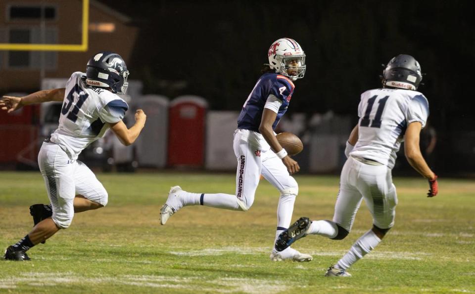 Stone Ridge Christian’s Anthony Wareham (51) and Sawyer Wood (11) chase down Modesto Christian quarterback Ross Widemon for a loss during the nonleague game at Modesto Christian High School in Salida, Calif., Friday, Sept. 15, 2023.