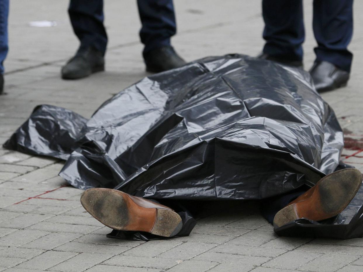 The covered body of Denis Voronenkov is seen outside a hotel in central Kiev: Reuters