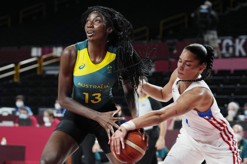 Australia's Ezi Magbegor (13) is defended by Puerto Rico's Tayra Melendez (1) during a women's basketball game at the 2020 Summer Olympics, Monday, Aug. 2, 2021, in Saitama, Japan. (AP Photo/Eric Gay)