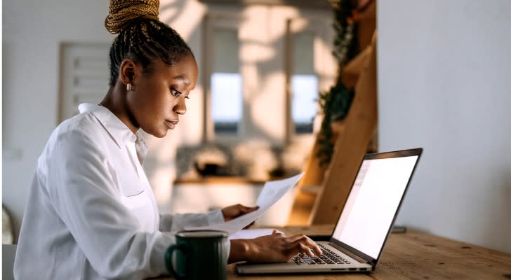 A woman looks over her Roth IRA contributions for the year.