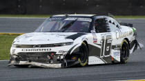 A J Allmendinger (16) heads through the infield after he was involved in a crash during the NASCAR Xfinity Series road course auto race at Daytona International Speedway, Saturday, Feb. 20, 2021, in Daytona Beach, Fla. (AP Photo/John Raoux)