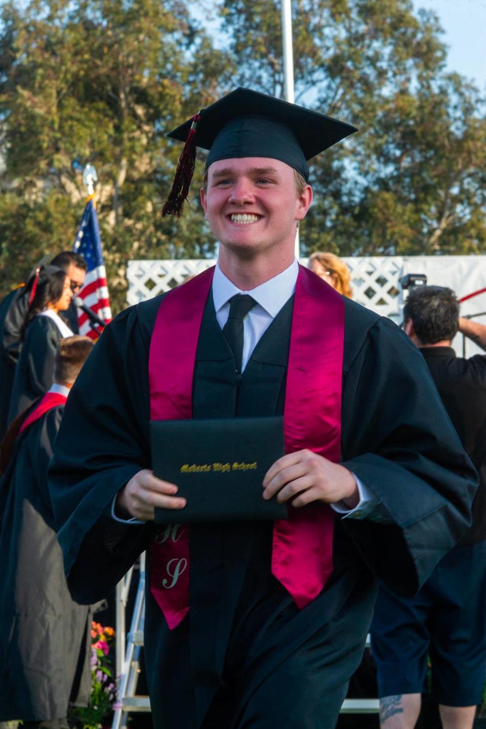 Riley Richards walks back to his seat after receiving is diploma during the Modesto High graduation. Modesto High School had their senior class walk the stage for graduation Thursday, May 25, 2023 at Modesto Junior College.