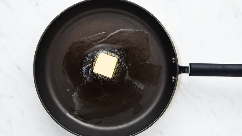 Butter melting in frying pan