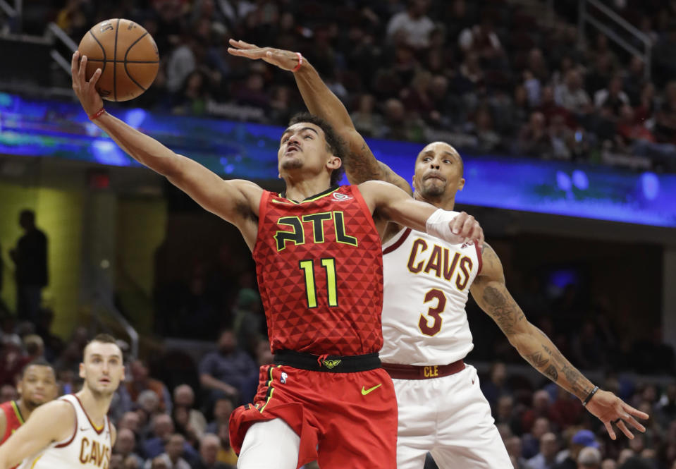 Atlanta Hawks' Trae Young (11) drives to the basket against Cleveland Cavaliers' George Hill (3) in the second half of an NBA basketball game, Tuesday, Oct. 30, 2018, in Cleveland. The Cavaliers won 136-114. (AP Photo/Tony Dejak)