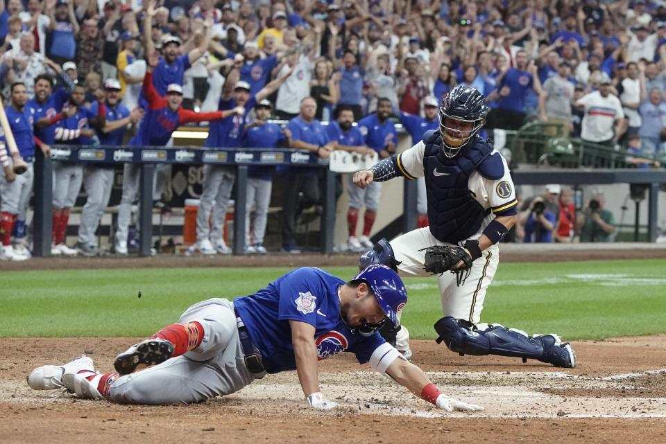 Chicago Cubs' Seiya Suzuki slides safely home after hitting an inside-the-park home run during the ninth inning of a baseball game against the Milwaukee Brewers Monday, July 4, 2022, in Milwaukee. (AP Photo/Morry Gash)