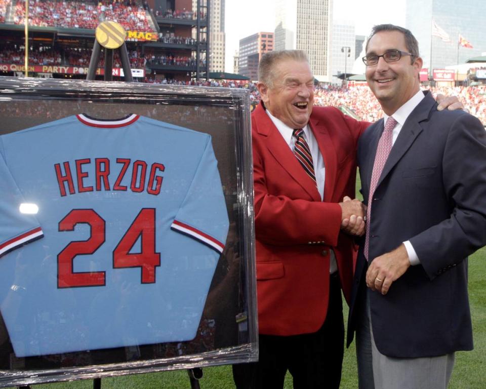 St. Louis Cardinals former manager hall-of-famer Whitey Herzog shares a laugh with team general manager John Mozeliak during a ceremony to retire his number before a baseball game between the Pittsburgh Pirates and the St. Louis Cardinals, Saturday, July 31, 2010.