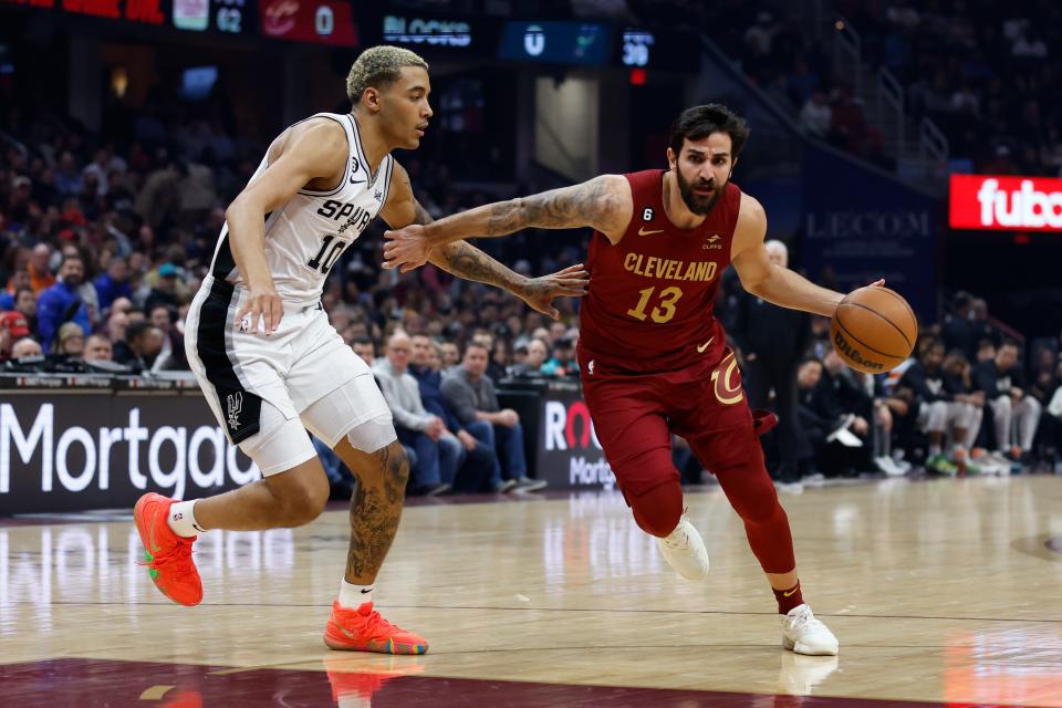 Cleveland Cavaliers guard Ricky Rubio (13) drives against San Antonio Spurs forward Jeremy Sochan (10) during the first half of an NBA basketball game, Monday, Feb. 13, 2023, in Cleveland. (AP Photo/Ron Schwane)