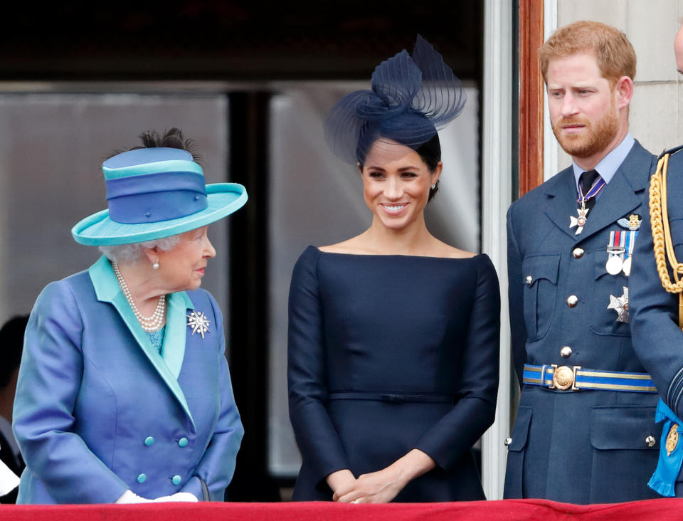 LONDON, UNITED KINGDOM - JULY 10: (EMBARGOED FOR PUBLICATION IN UK NEWSPAPERS UNTIL 24 HOURS AFTER CREATE DATE AND TIME) Queen Elizabeth II, Meghan, Duchess of Sussex and Prince Harry, Duke of Sussex watch a flypast to mark the centenary of the Royal Air Force from the balcony of Buckingham Palace on July 10, 2018 in London, England. The 100th birthday of the RAF, which was founded on on 1 April 1918, was marked with a centenary parade with the presentation of a new Queen's Colour and flypast of 100 aircraft over Buckingham Palace. (Photo by Max Mumby/Indigo/Getty Images)