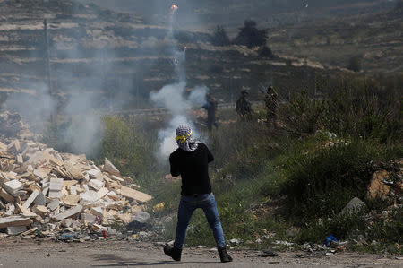 A Palestinian protester releases fireworks towards Israeli troops during clashes near the Jewish settlement of Beit El, in the Israeli-occupied West Bank March 20, 2019. REUTERS/Mohamad Torokman