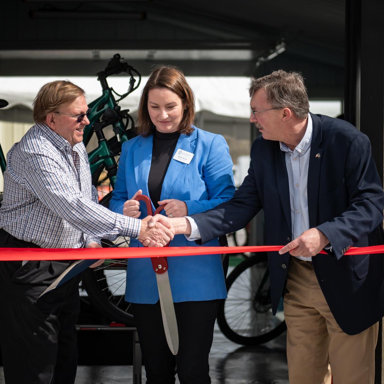 Owner Bill Chromczak, Executive Director at Clinton Chamber of Commerce Molly Marris and New York State Assemblyman Brian D. Miller get ready to cut the ribbon at the new eBliss Experience Center in Clinton, NY on Saturday, April 27, 2024.