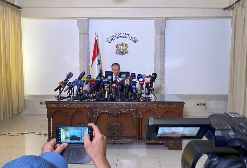 Head of the higher constitutional court, Jihad Al Laham, speaks during a news conference in Damascus