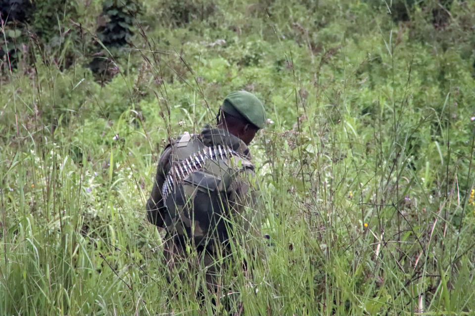 A member of the Congolese military searches an area leading to where bodies were found near to where a U.N. convoy was attacked and the Italian ambassador to Congo killed, in Nyiragongo, North Kivu province, Congo Monday, Feb. 22, 2021. The Italian ambassador to Congo Luca Attanasio, an Italian Carabineri police officer and their Congolese driver were killed Monday in an attack on a U.N. convoy in an area that is home to myriad rebel groups, the Foreign Ministry and local people said. (AP Photo/Justin Kabumba)