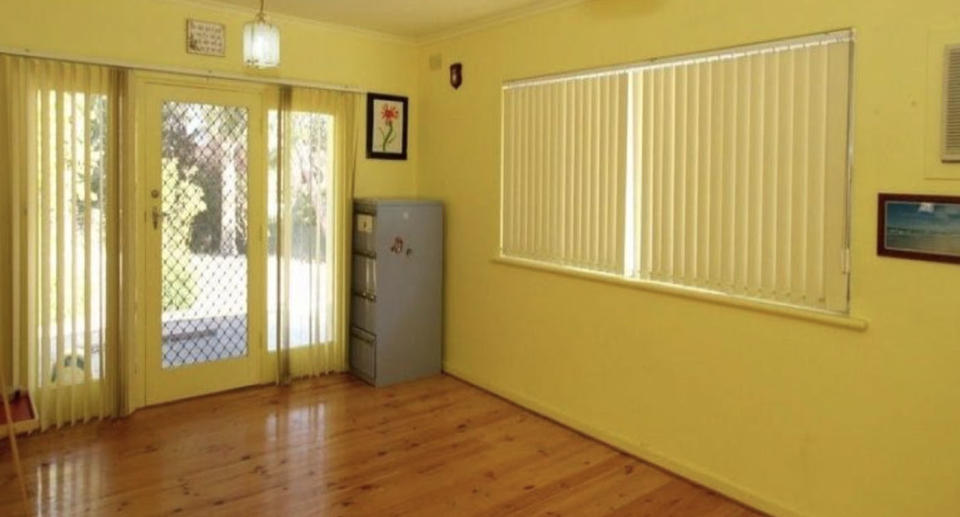A dark room with blinds drawn